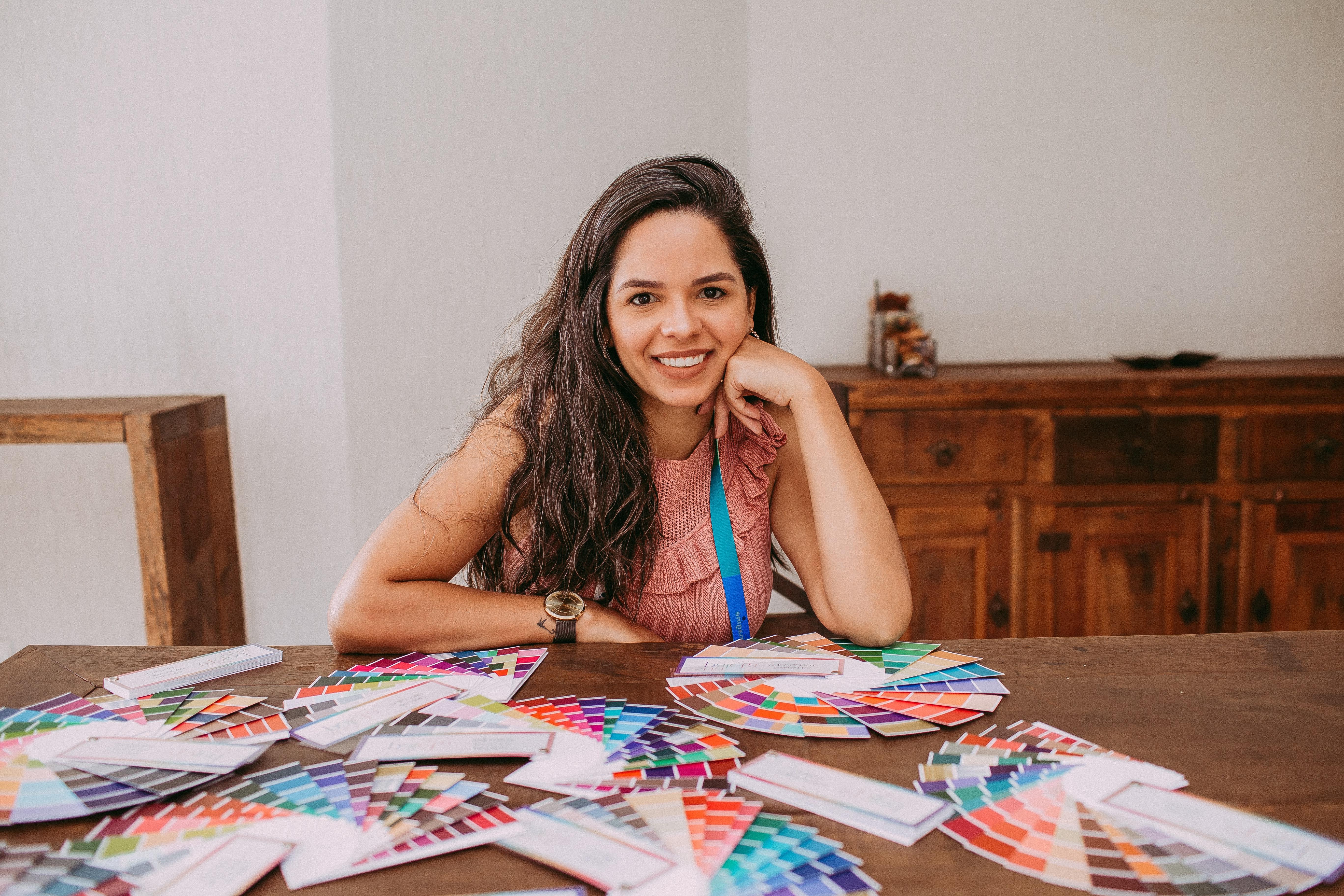 Female graphic designer with many palettes on a table